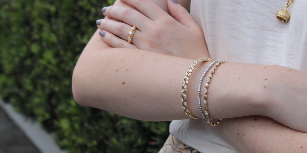 Sale collection, crossed arms, diamond bracelets and bangle stack