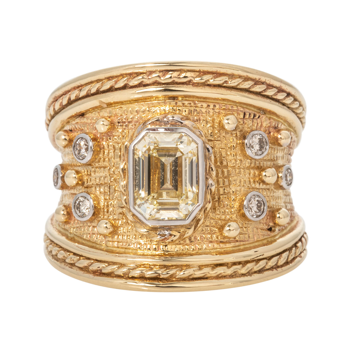 14K yellow gold Byzantine-style ring with an emerald-cut diamond center, round diamond accents, and rope borders.