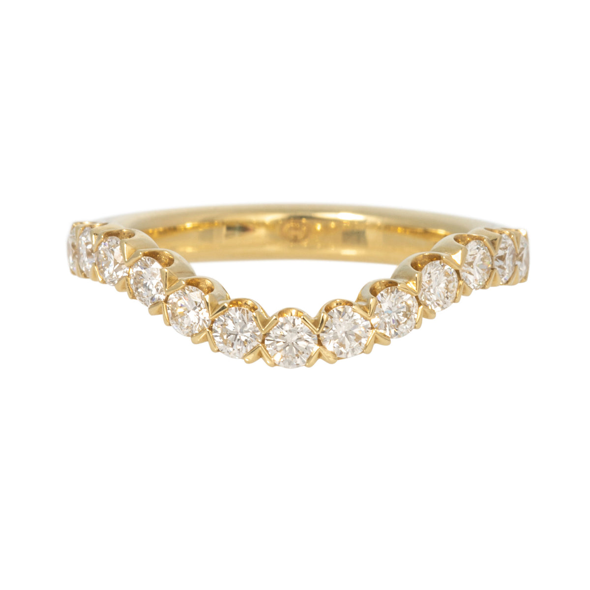 18K yellow gold curved band with prong-set round diamonds following a gentle dip at the center.