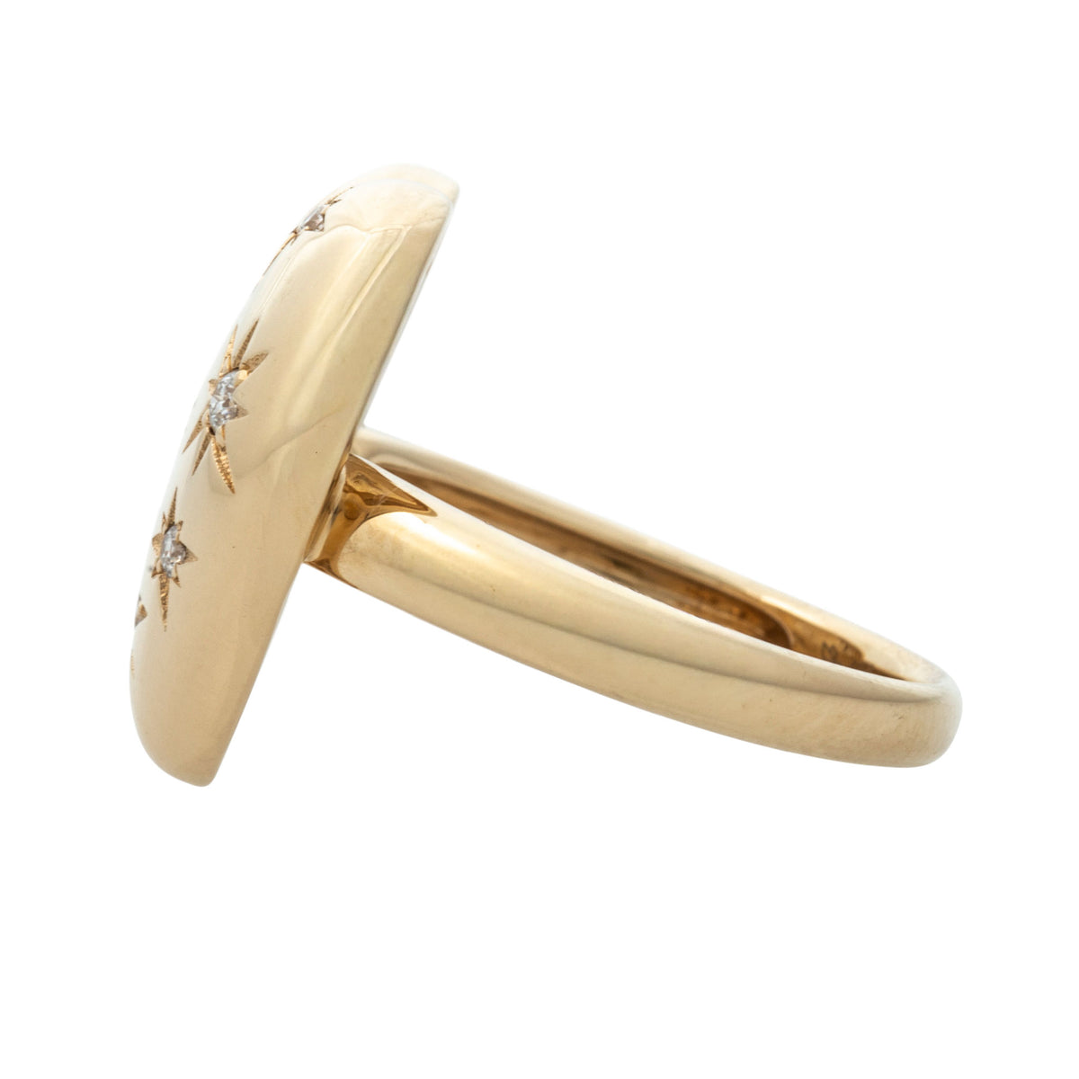 Side view of the diamond starburst 18K yellow gold pouf heart ring showing its raised heart and smooth band.