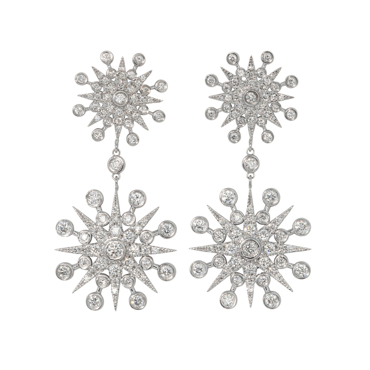 Pair of 14K white gold diamond drop earrings with two linked starbursts featuring pavé-set rays and bezel-set round diamonds.