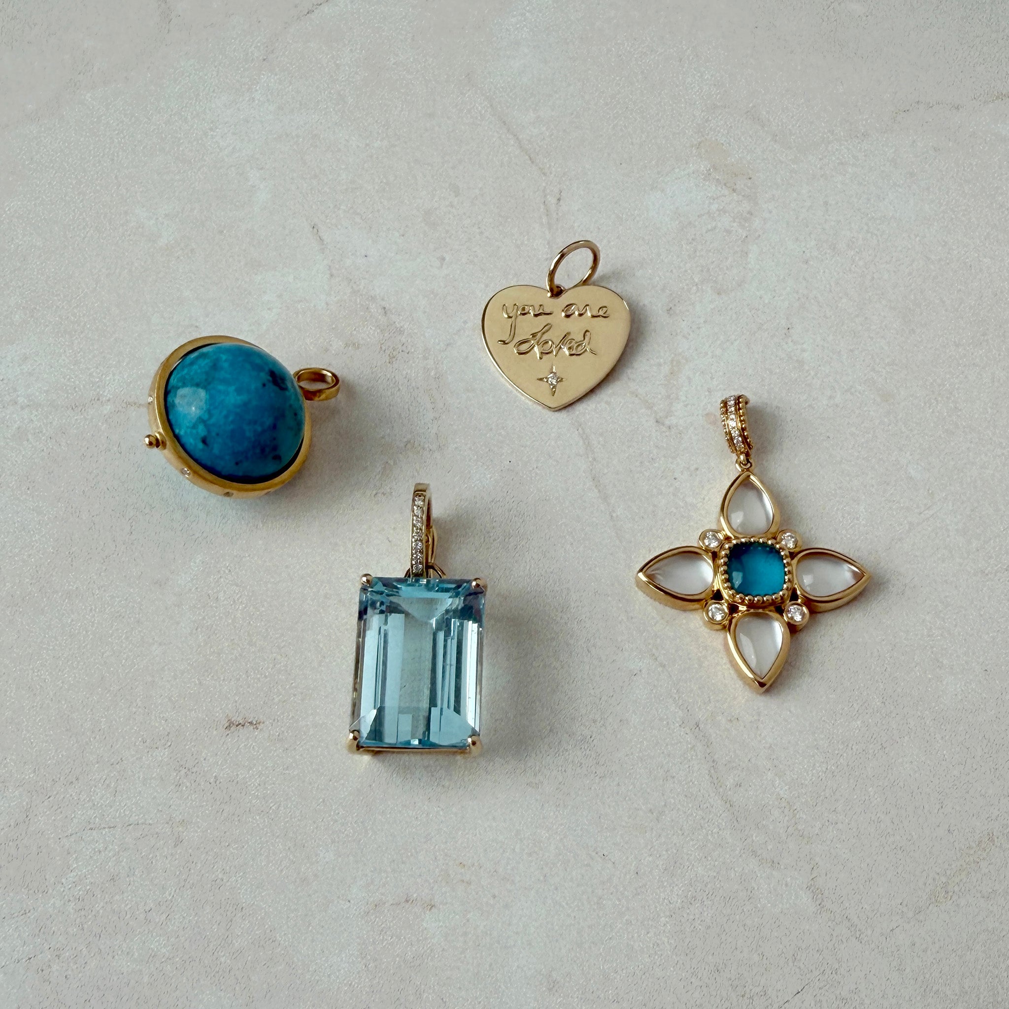 Turquoise & Diamond 14K Yellow Gold Spinning Globe Pendant, 'You are Loved' Diamond 14K Yellow Gold Heart Pendant, 15.60ctw Emerald-Cut Blue Topaz & Diamond 14K Yellow Gold Pendant, Turquoise, Mother of Pearl & Quartz Doublet 18K Gold Pendant