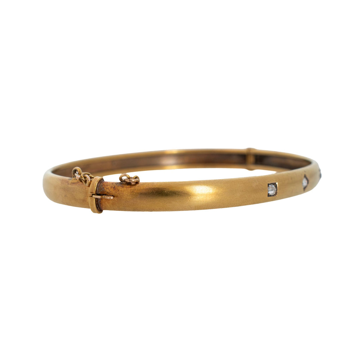 Angled side view of the Victorian 15K yellow gold diamond bangle showing the clasp and safety chain.