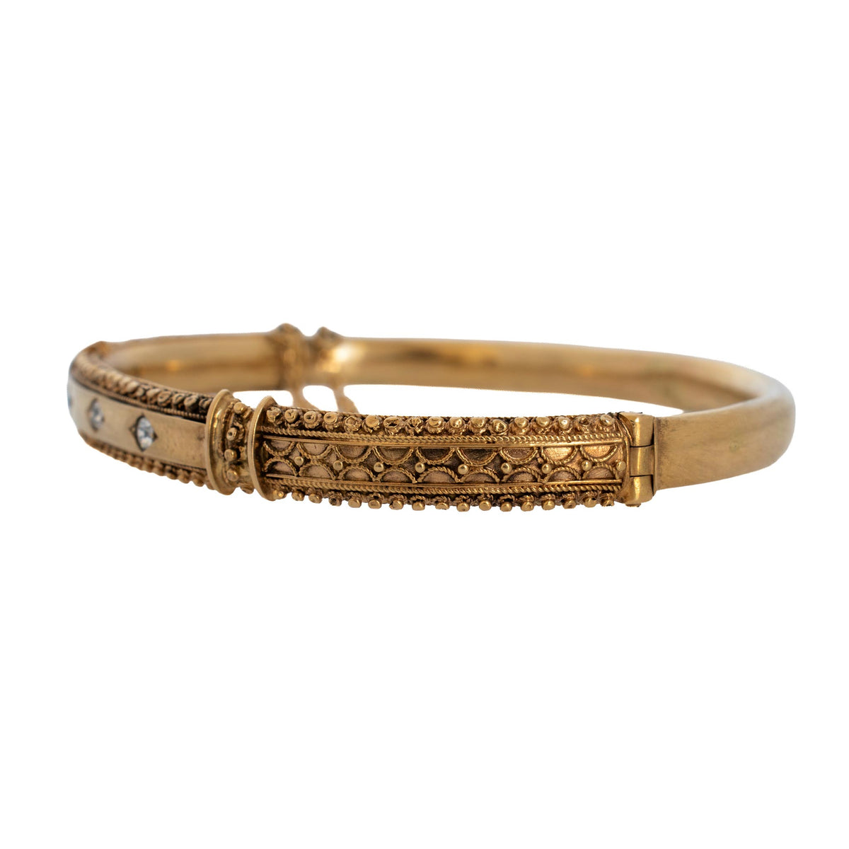 Side view of Victorian Etruscan Revival diamond gold bangle showing decorative wirework, beaded edges, and hinge.