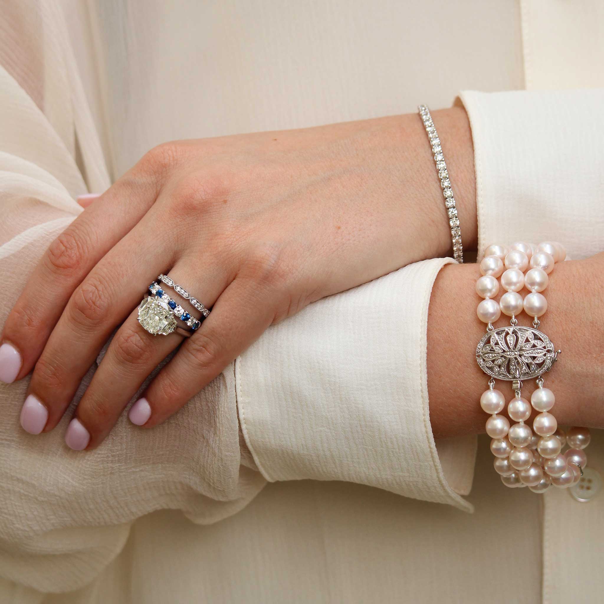 4ct Cushion Center & .62ct Side Diamond Three-Stone Platinum Ring, .65ct Sapphire & .36ct Diamond Halfway 14K White Gold Band, Diamond 14K White Gold Milgrain Band, Three-Strand Akoya Pearl & Diamond Clasp 14K Gold Bracelet, 5ctw Diamond 14K White Gold Tennis Bracelet