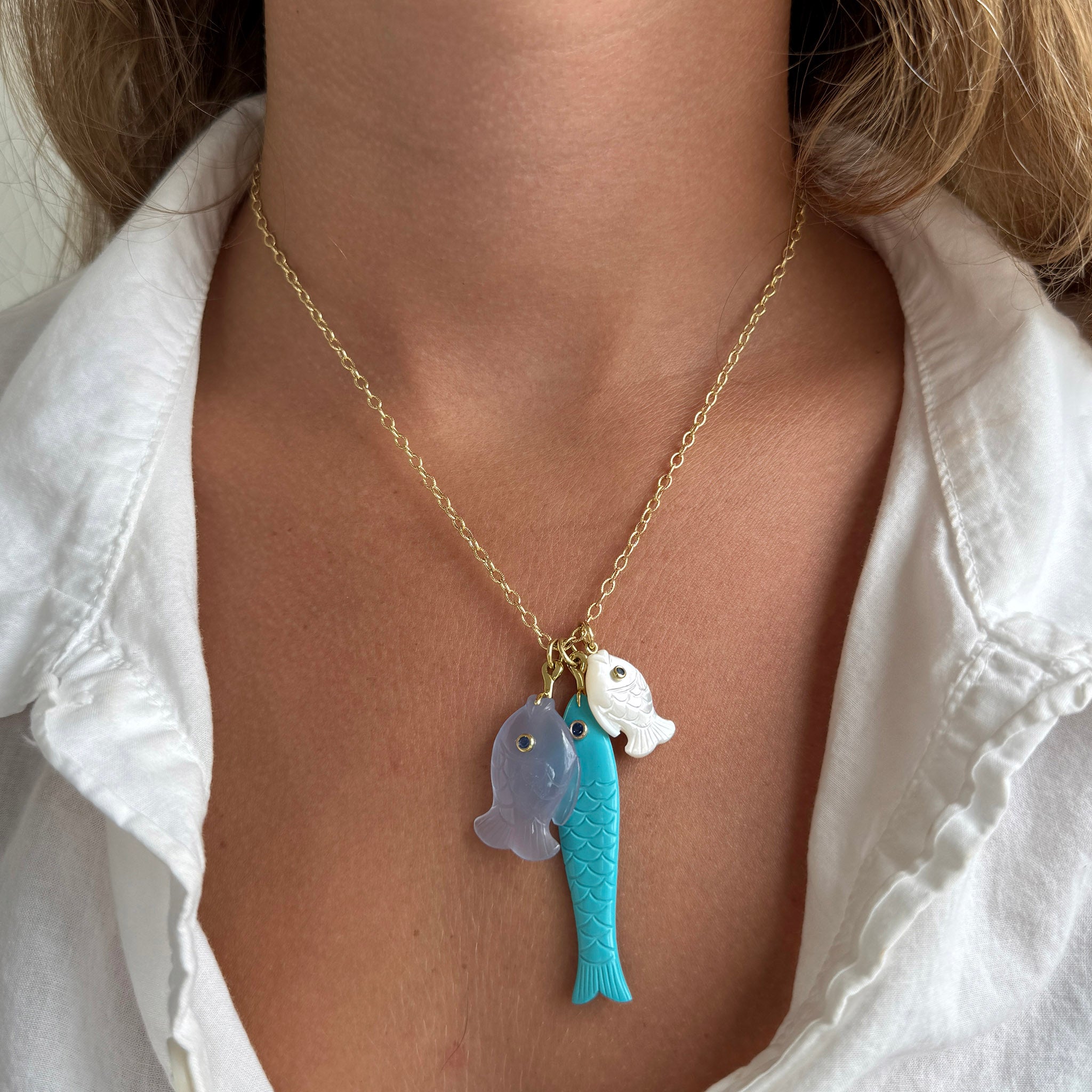 Mazza Hand Carved Fish Pendants on a chain.