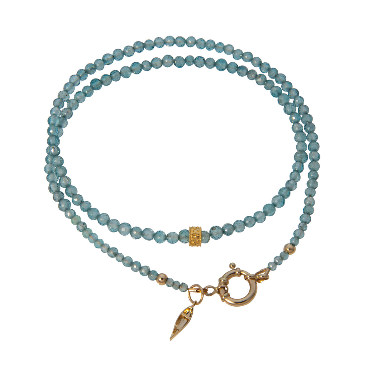 Tippy Stern faceted blue zircon beaded necklace with an ornate yellow gold rondelle, spacer beads, and canoe charm.