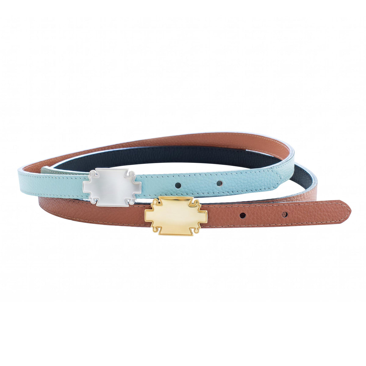 Two narrow belts crossed, one light blue with a silver plaque buckle and one saddle brown with a gold plaque buckle, on a white background.