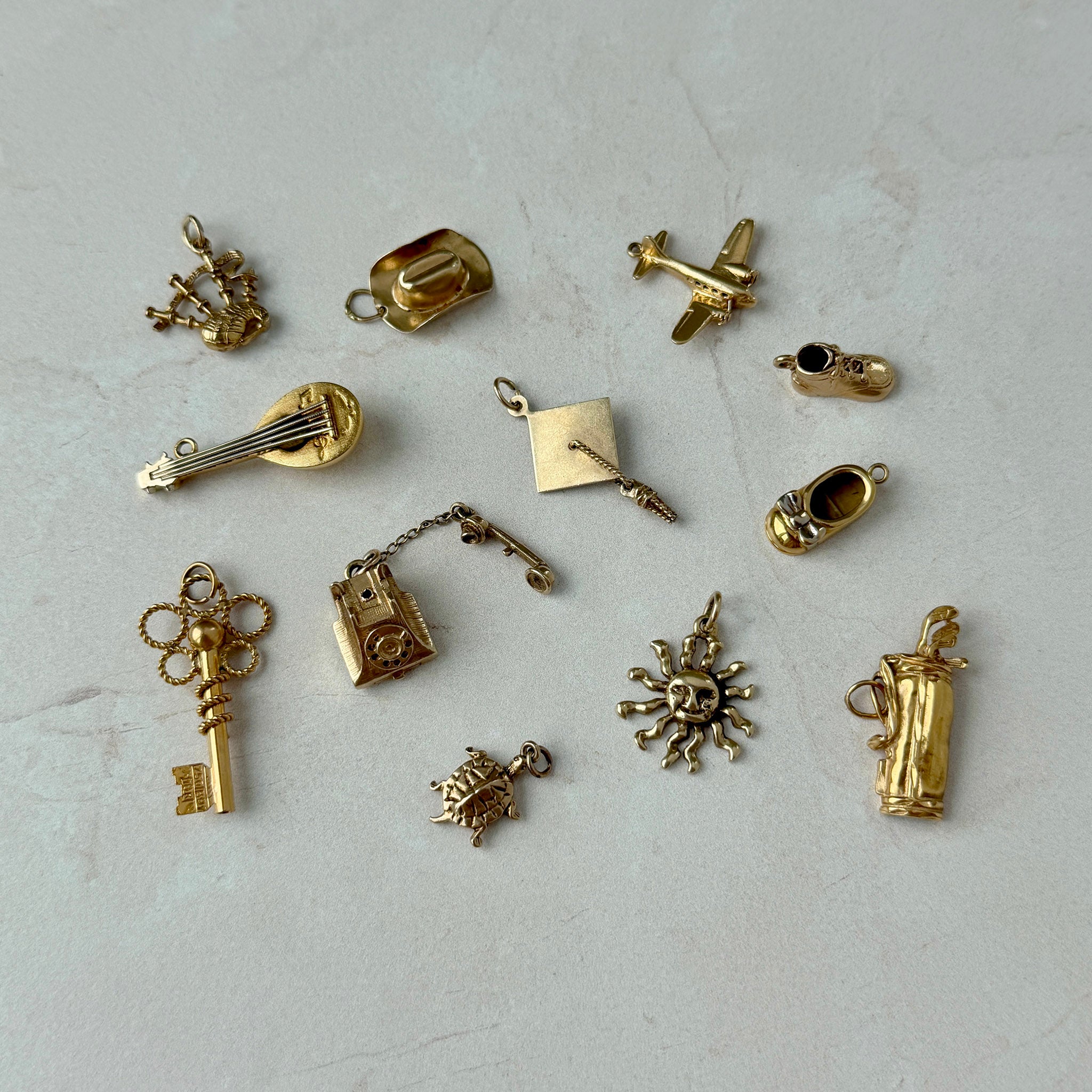 Vintage 14K Gold Cowboy Hat Charm, Vintage 14K Gold Graduation Cap Charm, Vintage 9K Gold Scottish Bagpipes Charm, Vintage 9K Gold Rotary Telephone Charm, Vintage 14K Gold Golf Clubs Bag Charm, Vintage 14K Gold Propeller Airplane Charm, Vintage 18K Gold Skeleton Key Charm, Vintage 14K Gold Turtle Charm, Vintage 14K Gold Baby Shoe Charm, Vintage 14K Gold Baby Bow Shoe Charm, Vintage 18K Gold Mandolin Lute Charm