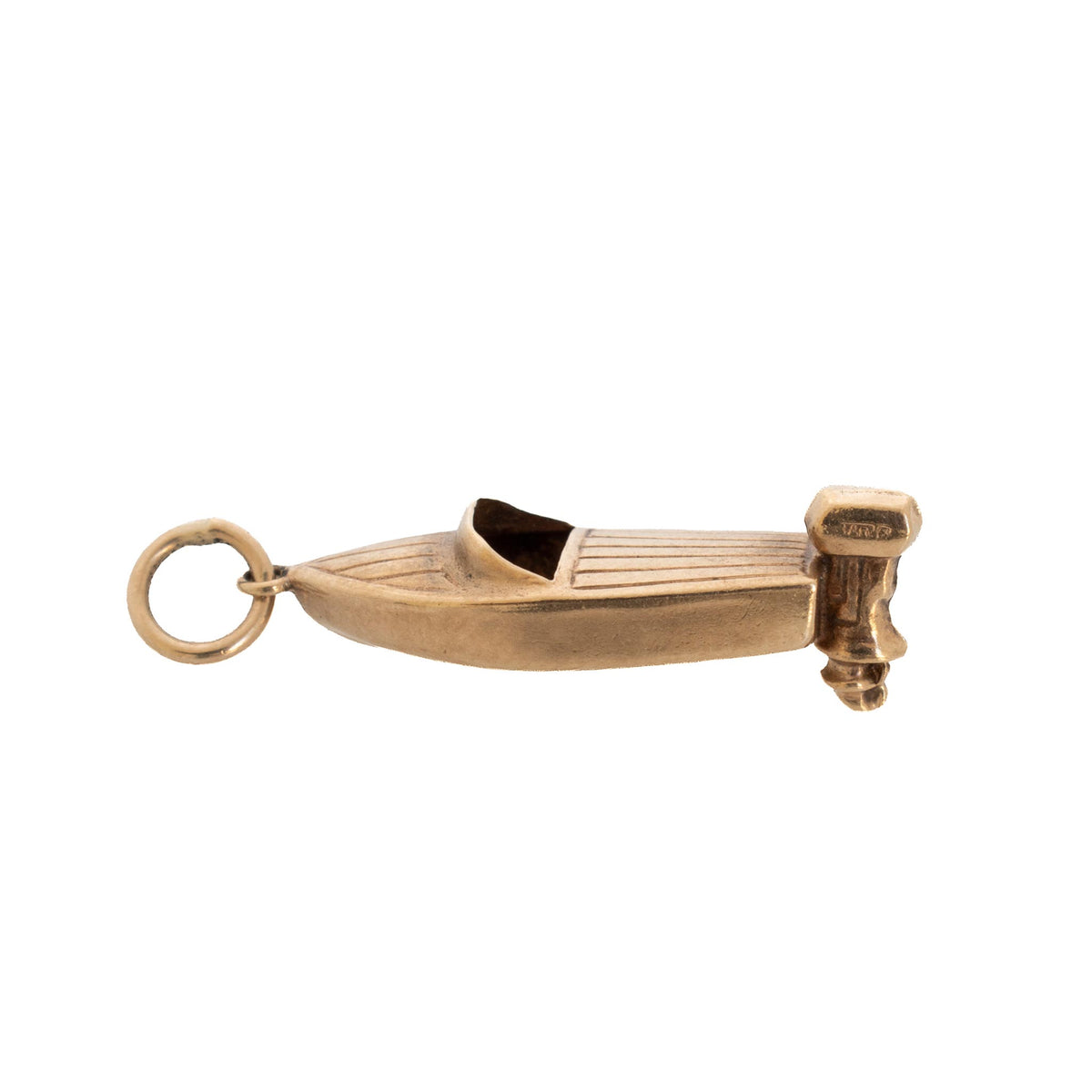 Side view of a vintage 9K yellow gold speedboat charm showing its hull, open cockpit, and outboard motor.