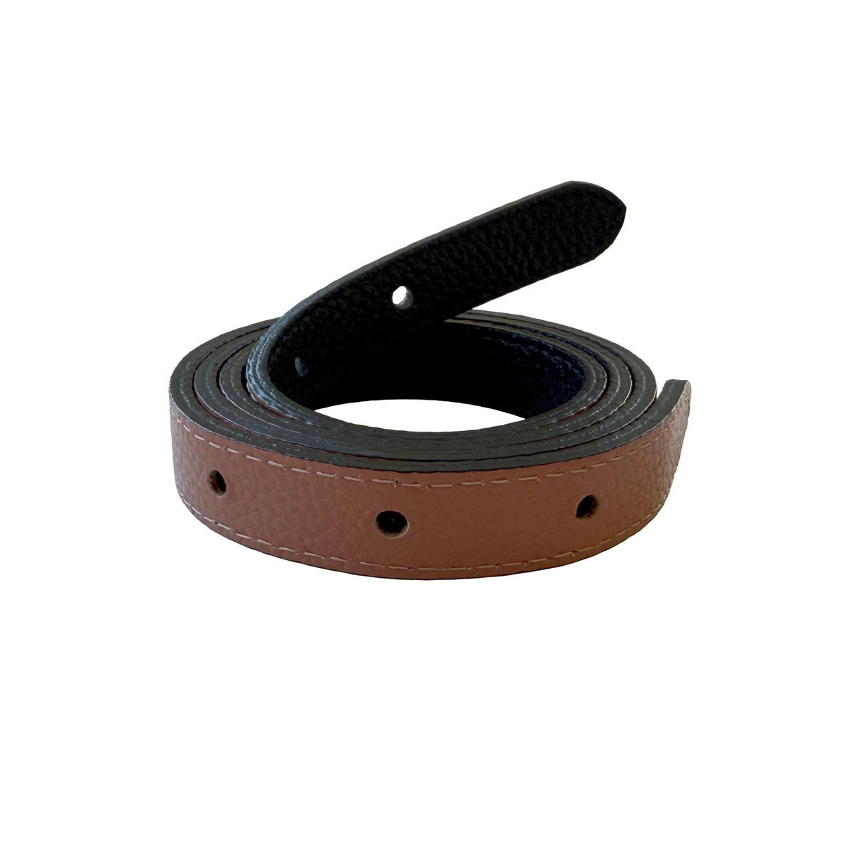 Reversible narrow belt strap coiled to show its saddle brown pebbled leather side and black underside.