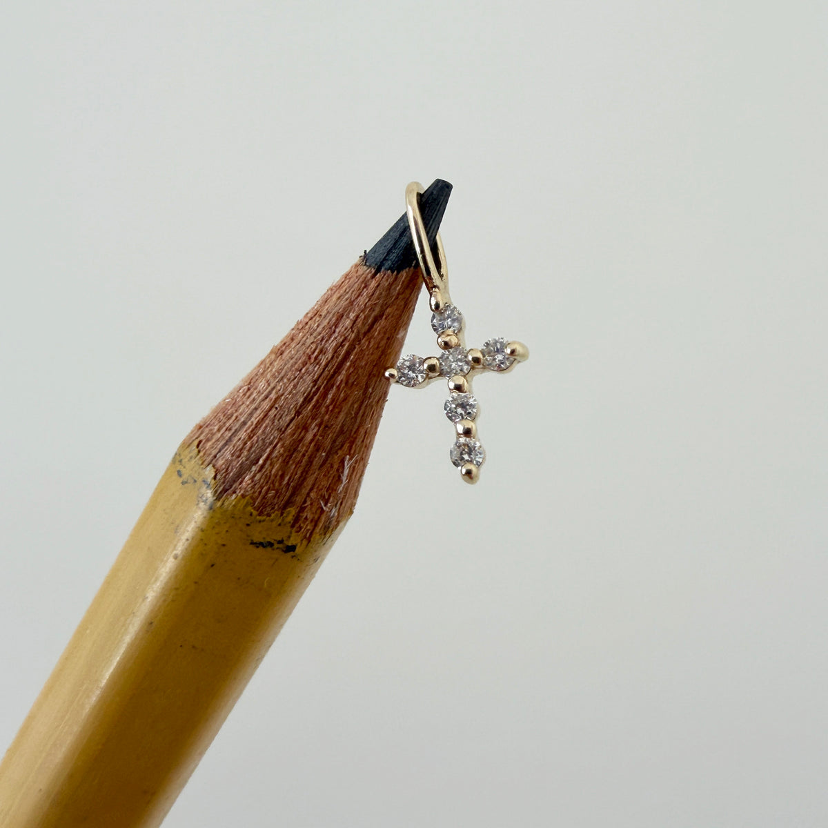 Diamond 14K Yellow Gold Petite Cross Charm on pencil
