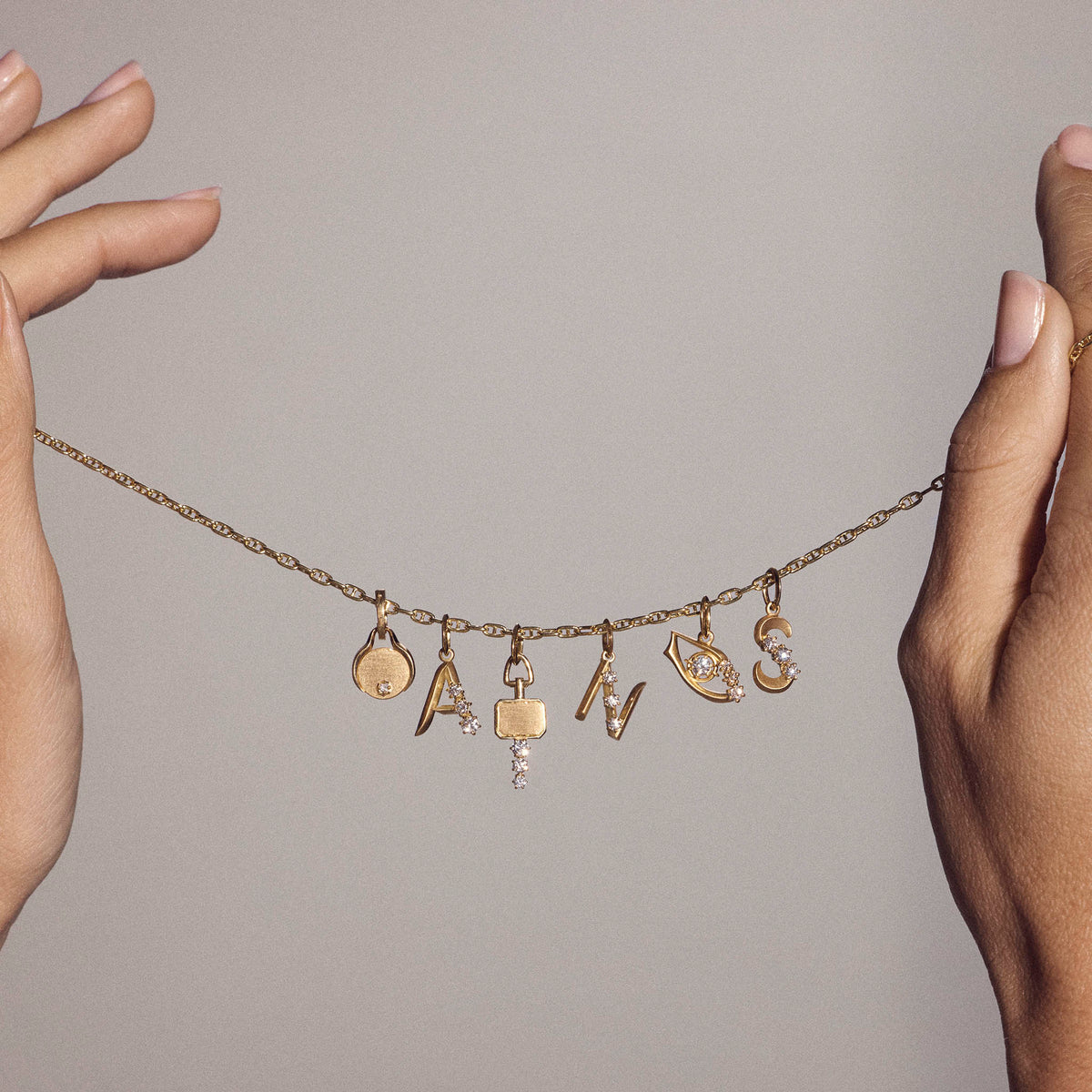 Jade Trau Letter Charms styled with other charms