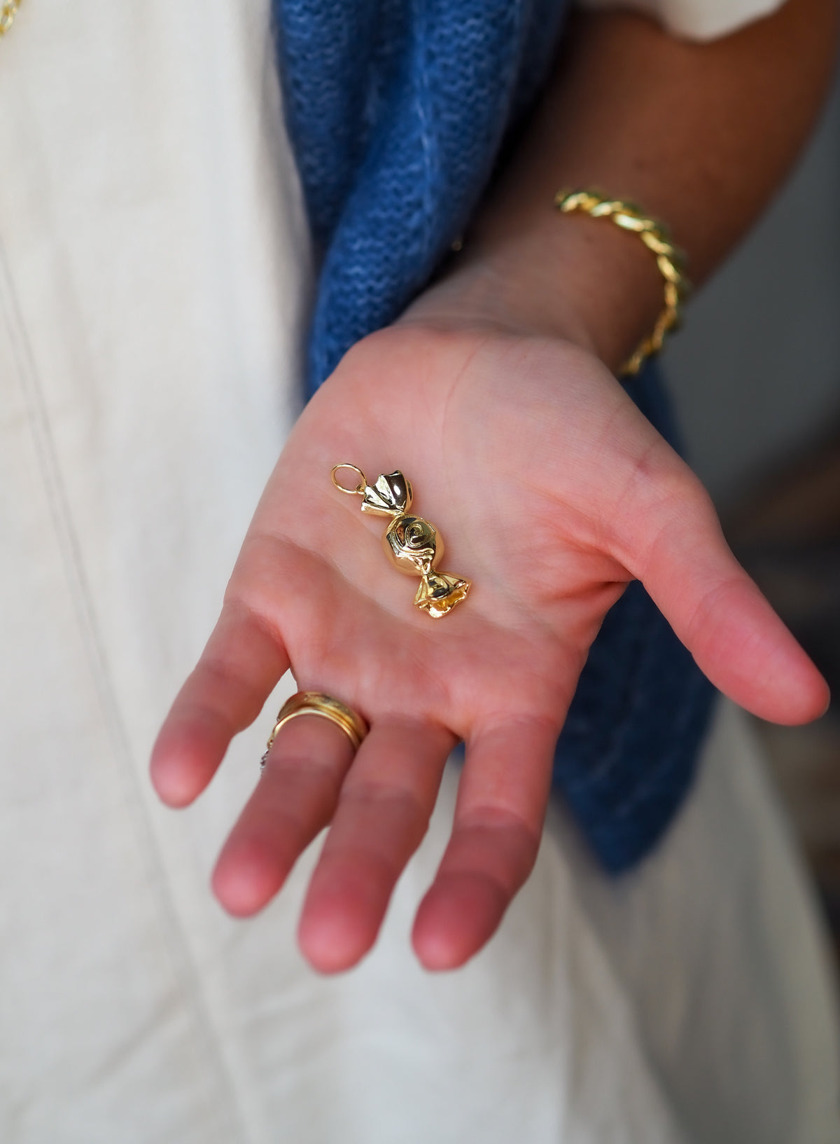 Model holding the Goldbug Candy Charm in the palm of their hand