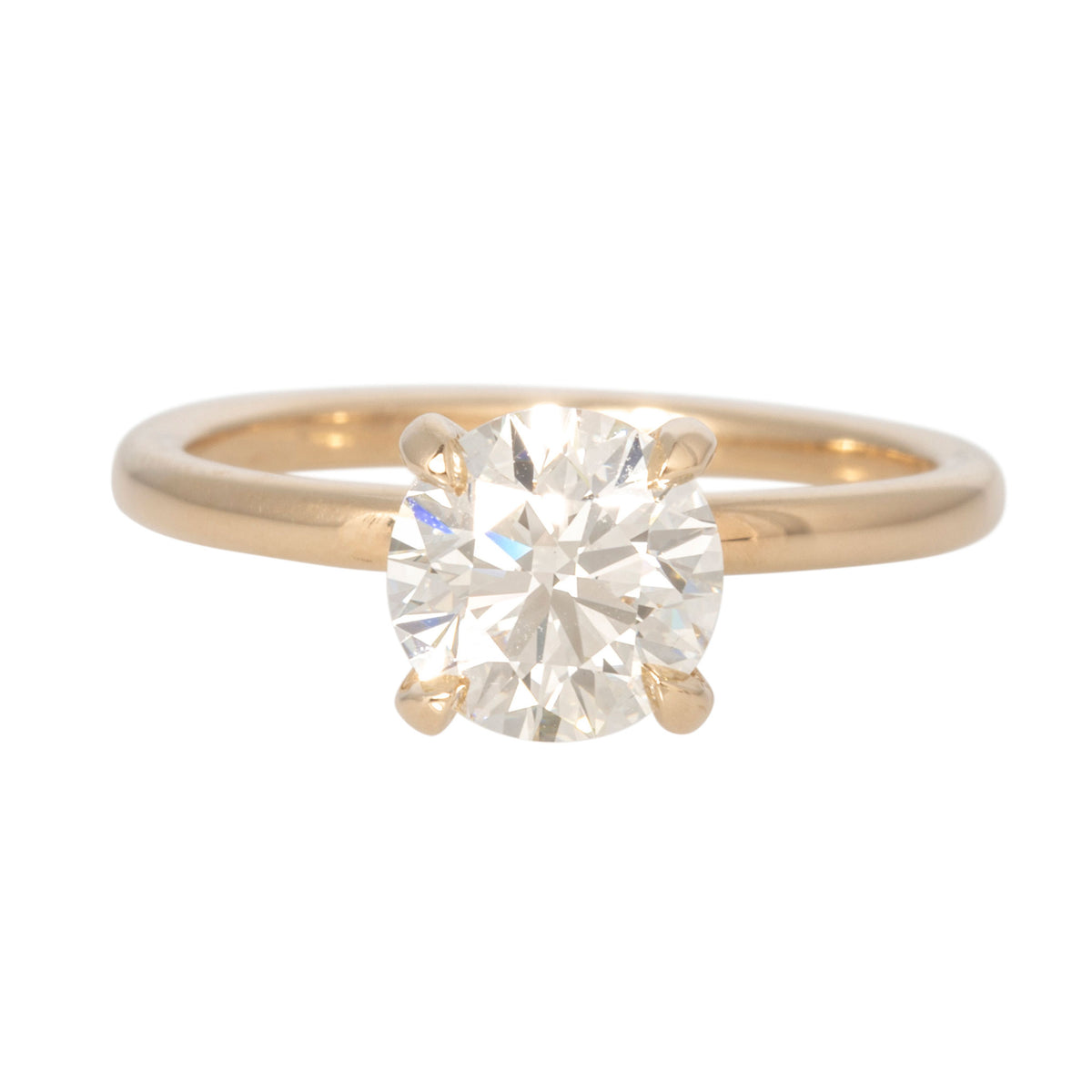Front view of a 1.5ct round diamond solitaire engagement ring with a four-prong setting and 14K yellow gold band.