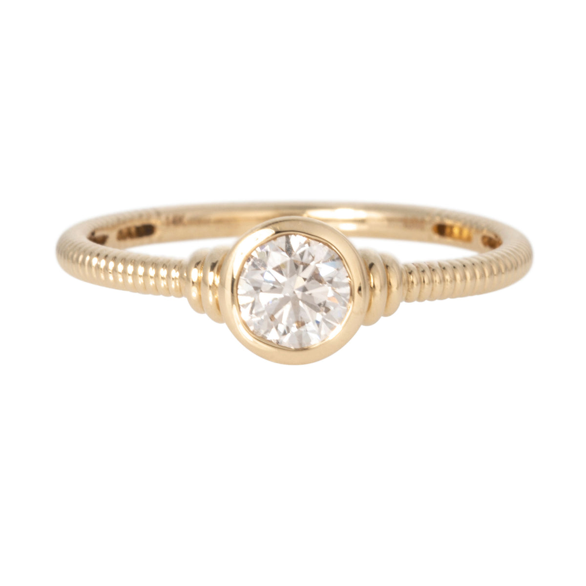 Round diamond solitaire ring with a bezel setting and ribbed 14K yellow gold band.