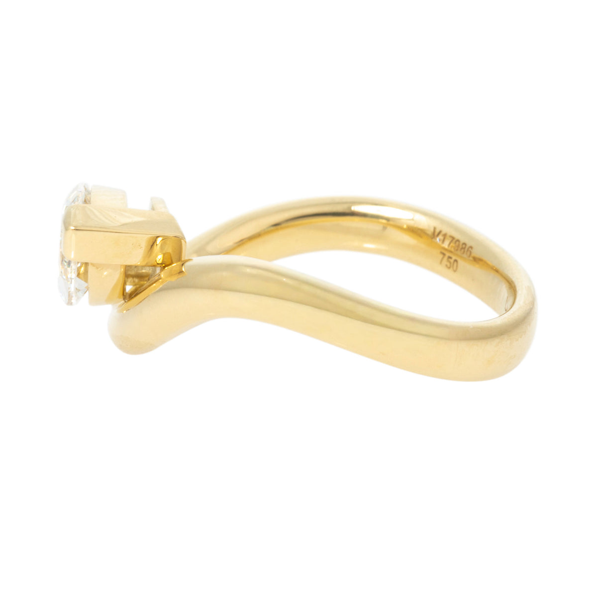 Side view of marquise diamond solitaire ring showing the raised setting and 18K yellow gold wave band.