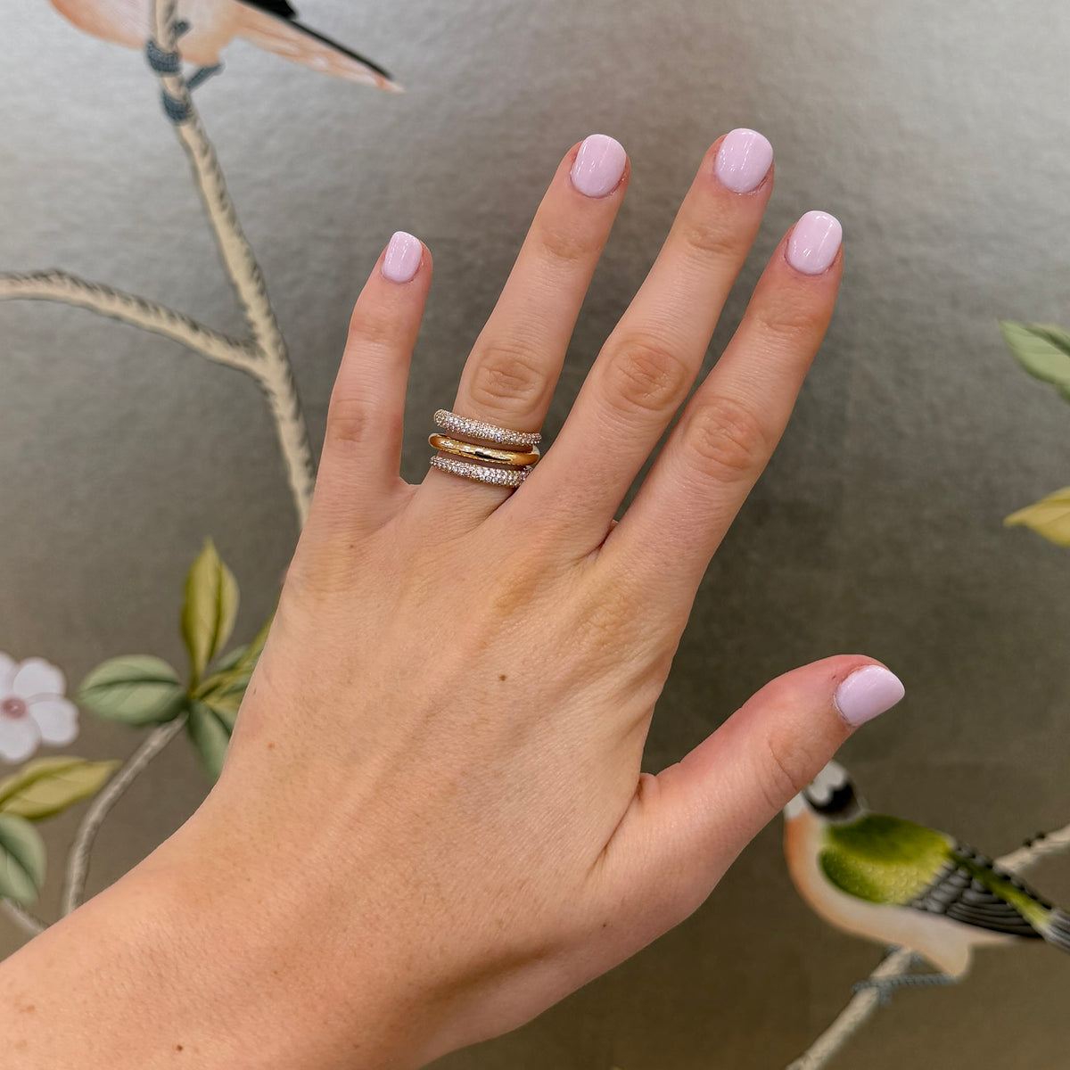 Diamond pavé 14K yellow gold bypass wrap ring worn on a hand, showing its three-row design and scale.