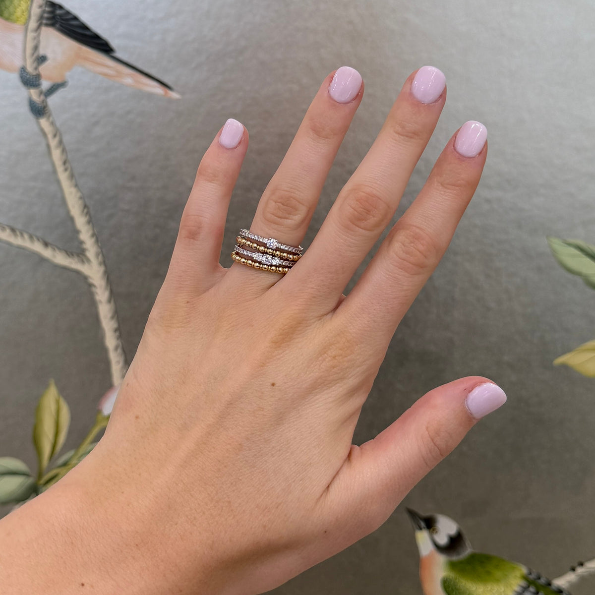 14K two-tone gold diamond coil wrap ring worn on a hand, showing its layered rows and scale.