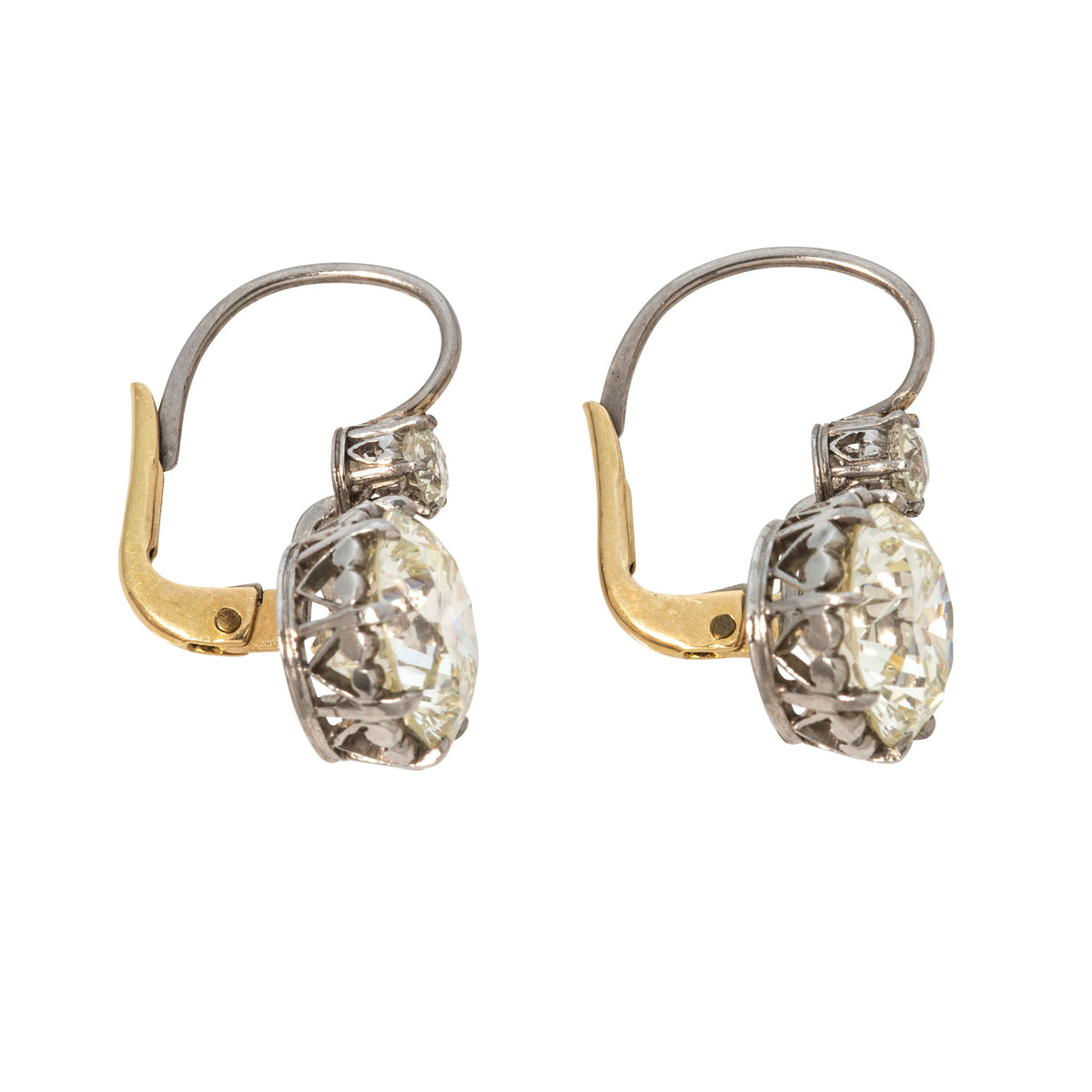 Side view of diamond double drop earrings showing ornate platinum settings and yellow gold leverbacks.