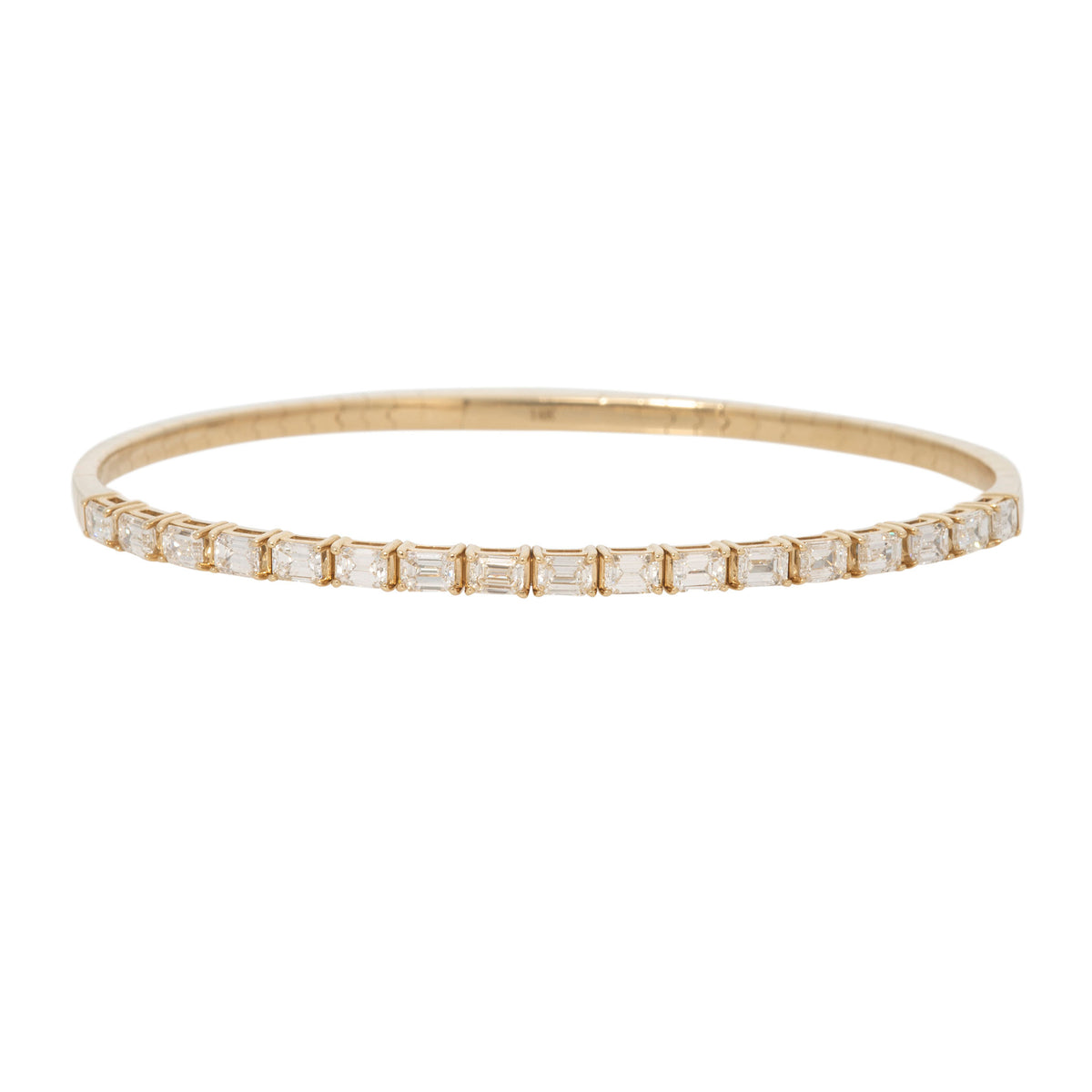 14K yellow gold flexible bangle with a row of prong-set emerald-cut diamonds, shown on a white background.