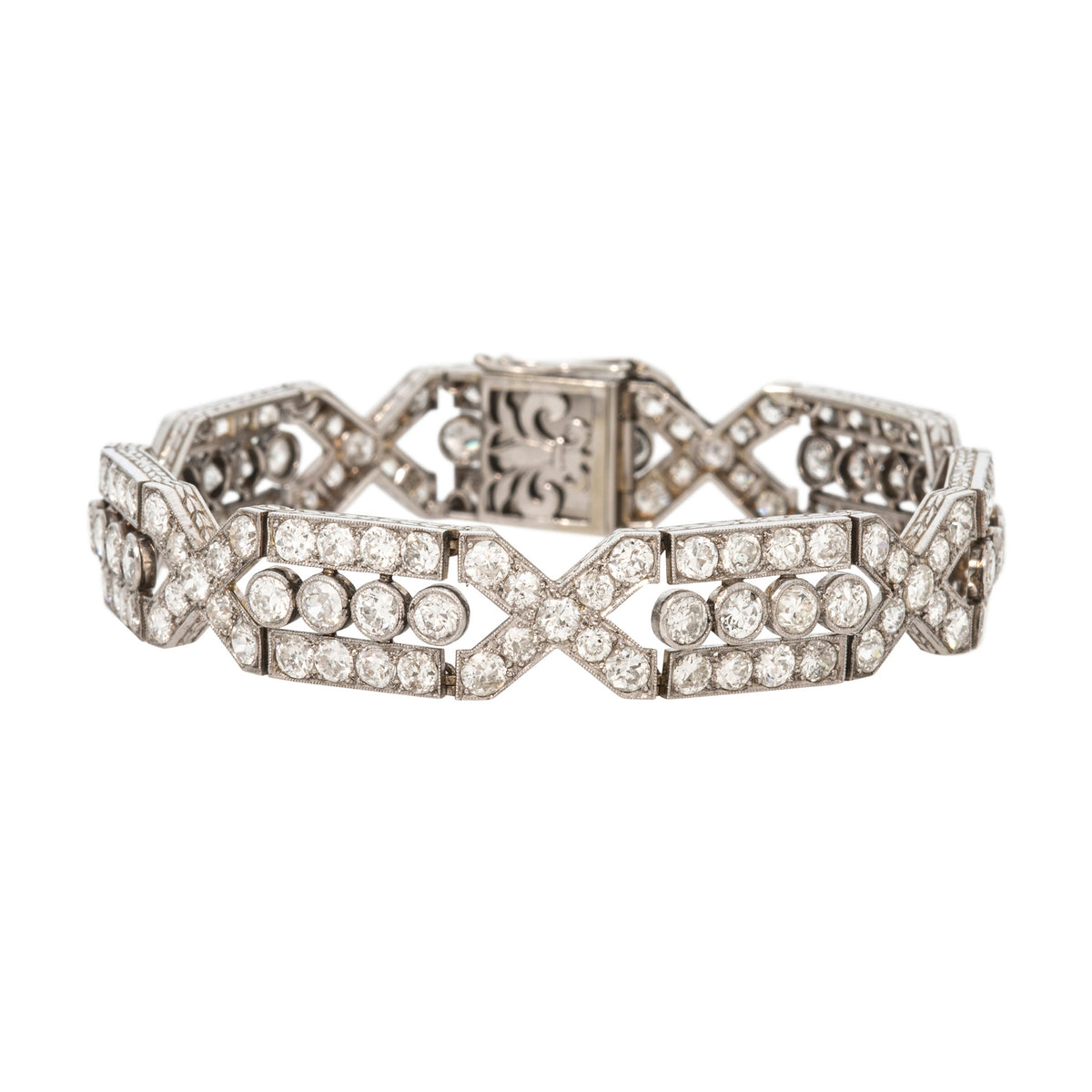 French Art Deco-style platinum bracelet with diamond-set rectangular and X-shaped links, shown on a white background.