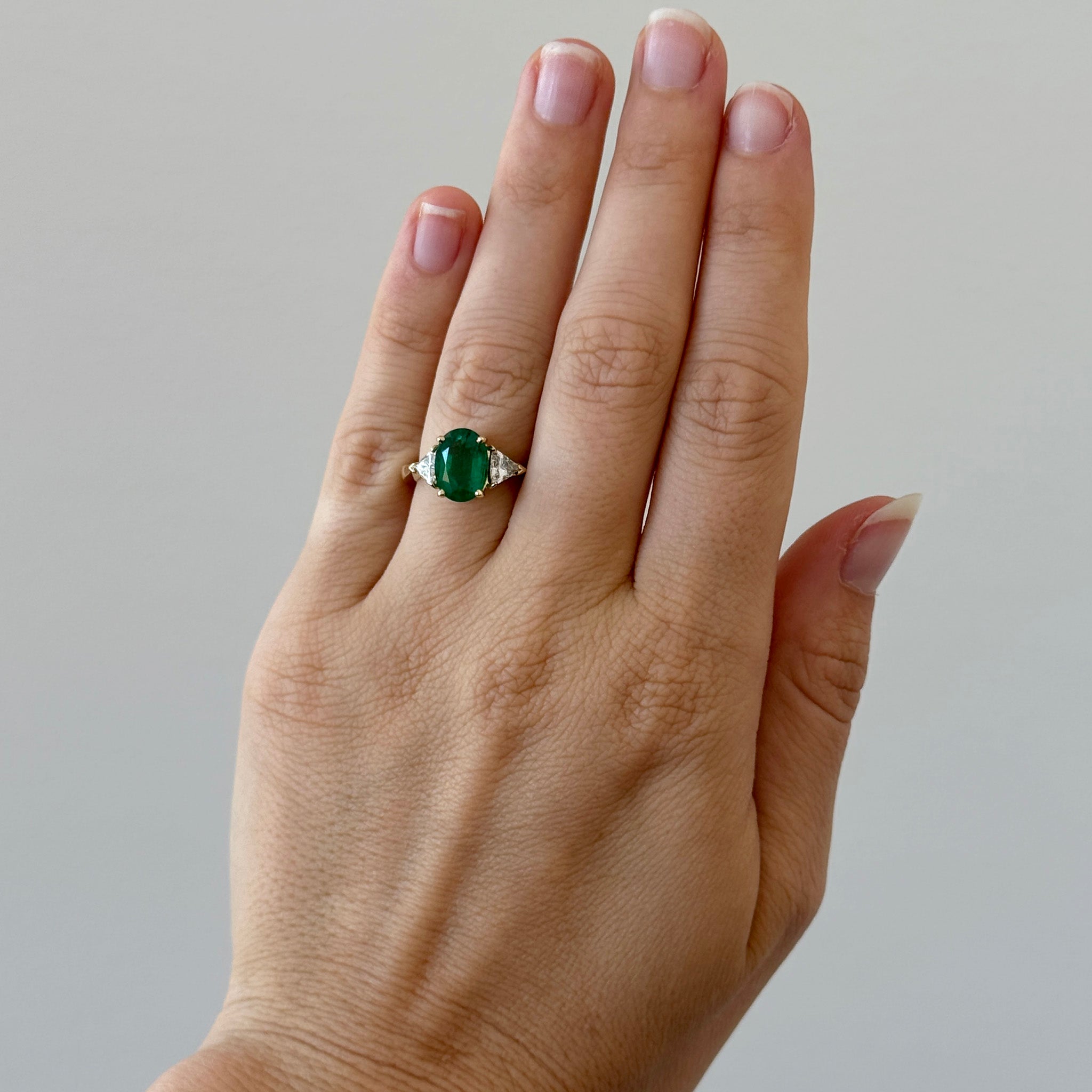 2.43ct Oval Emerald & Trillion Diamond Three-Stone 18K Gold Ring