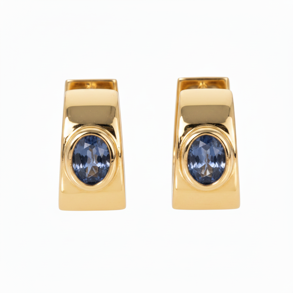 Oval sapphire bezel set in 18K yellow gold huggie earrings with high-polish finish