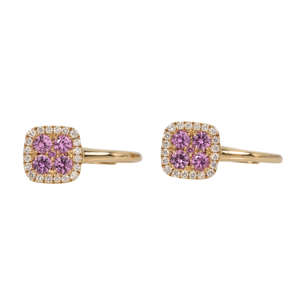 Pink sapphire and diamond cushion cluster earrings laid flat at an angle, showing the gemstone faces and yellow gold leverbacks.