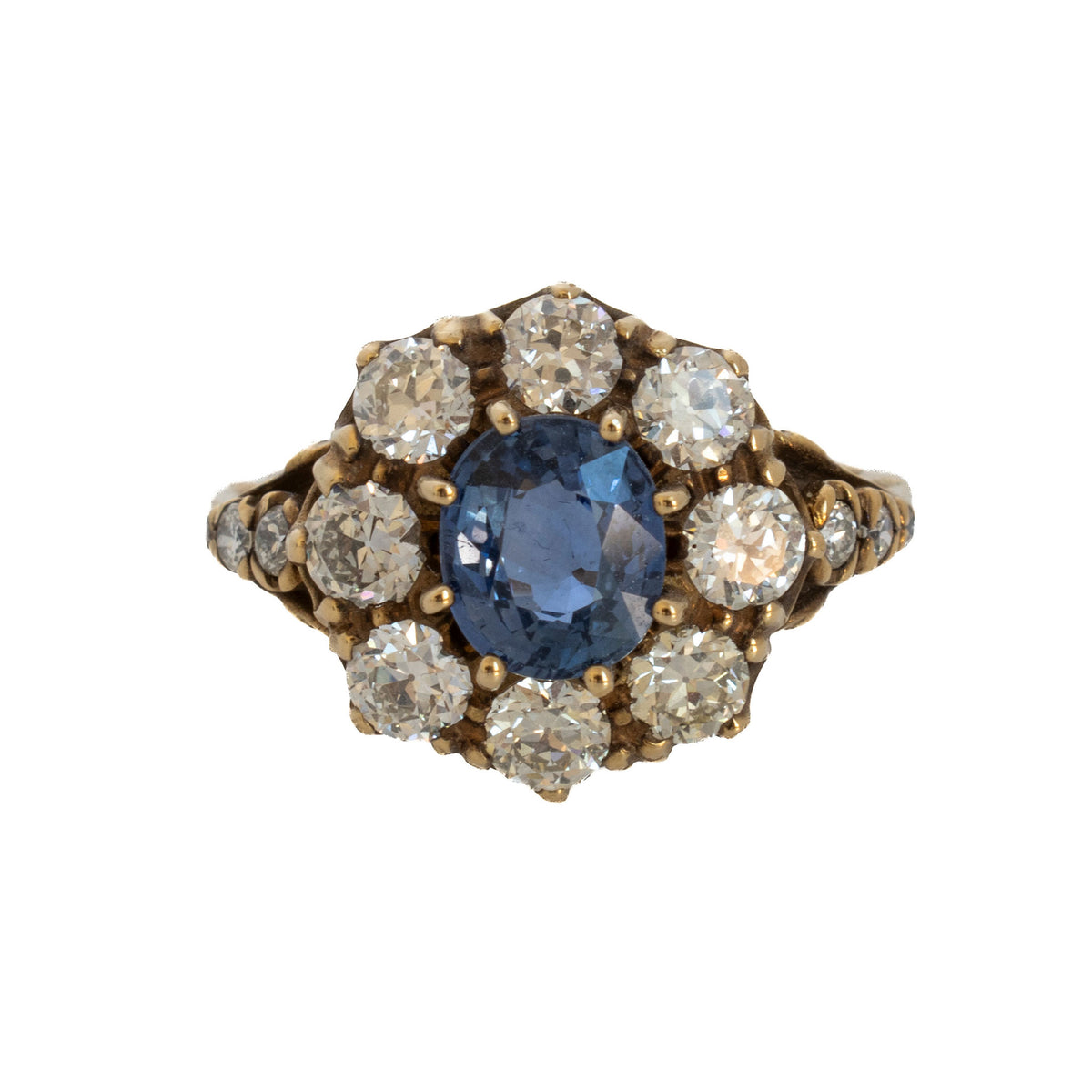 Edwardian 18K gold ring with an oval blue sapphire surrounded by diamonds and diamond-set shoulders.