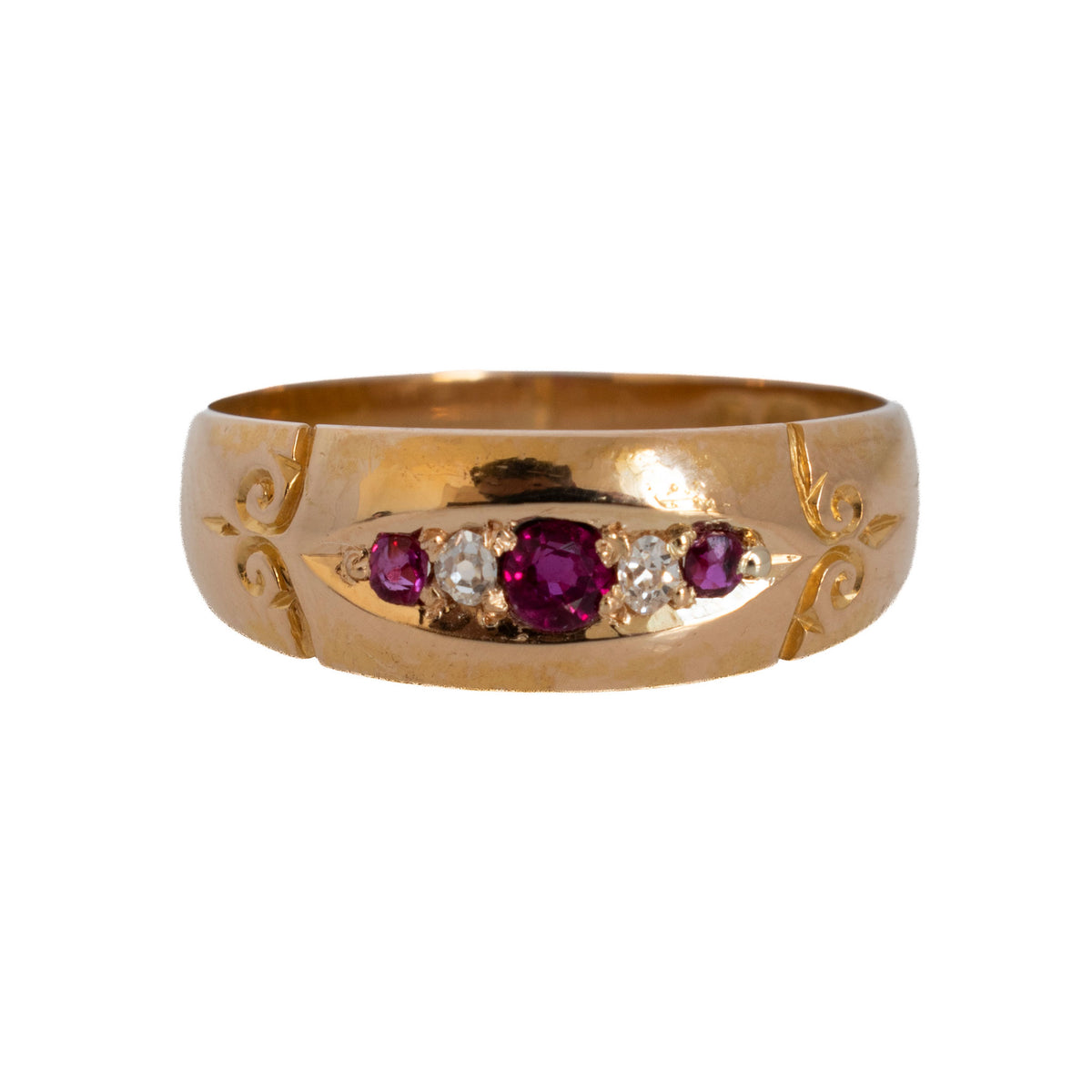 Victorian 18K yellow gold ring with three rubies alternating with two diamonds and engraved scroll details.