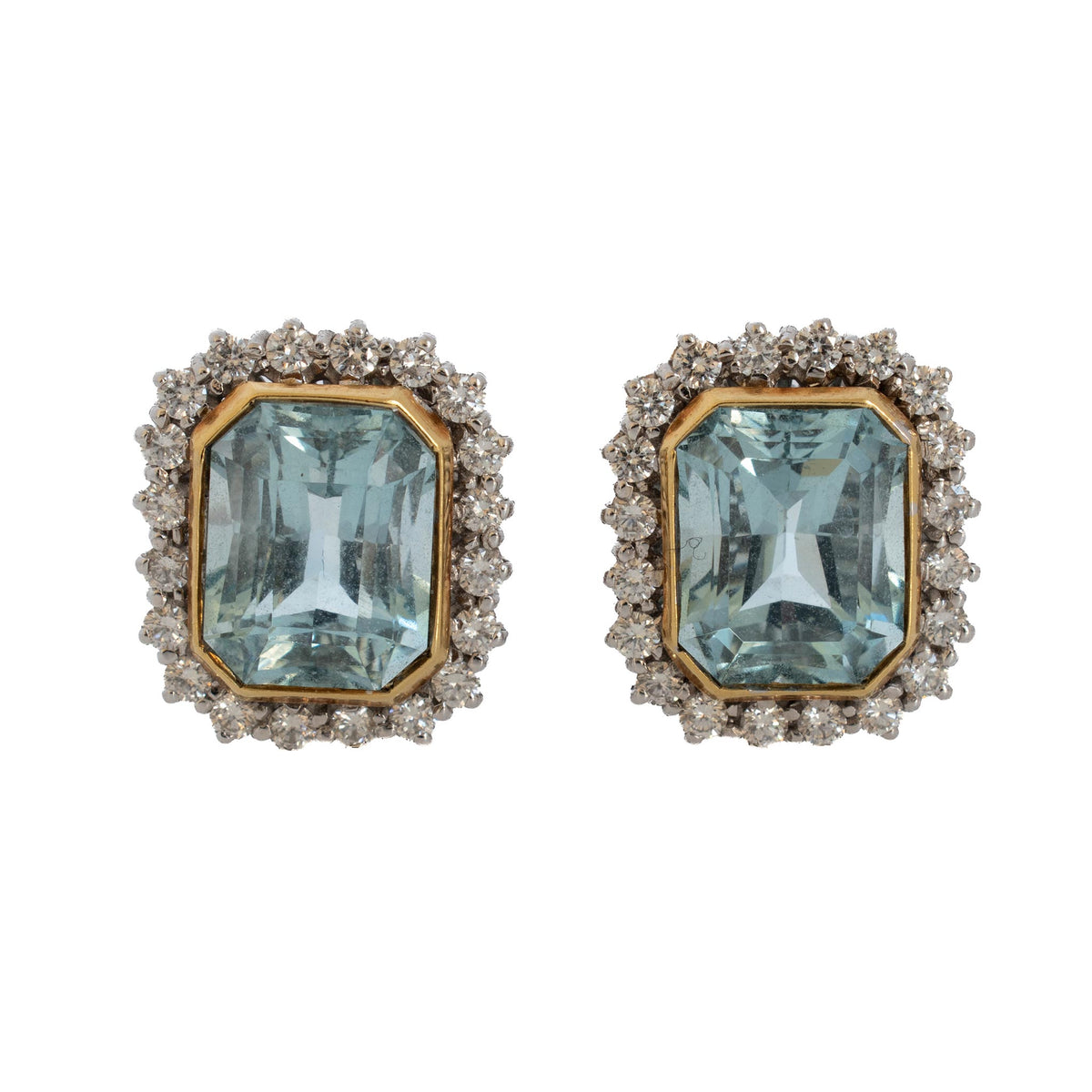 Estate 18K gold earrings with emerald-cut pale blue aquamarines in yellow gold bezels surrounded by diamond halos.