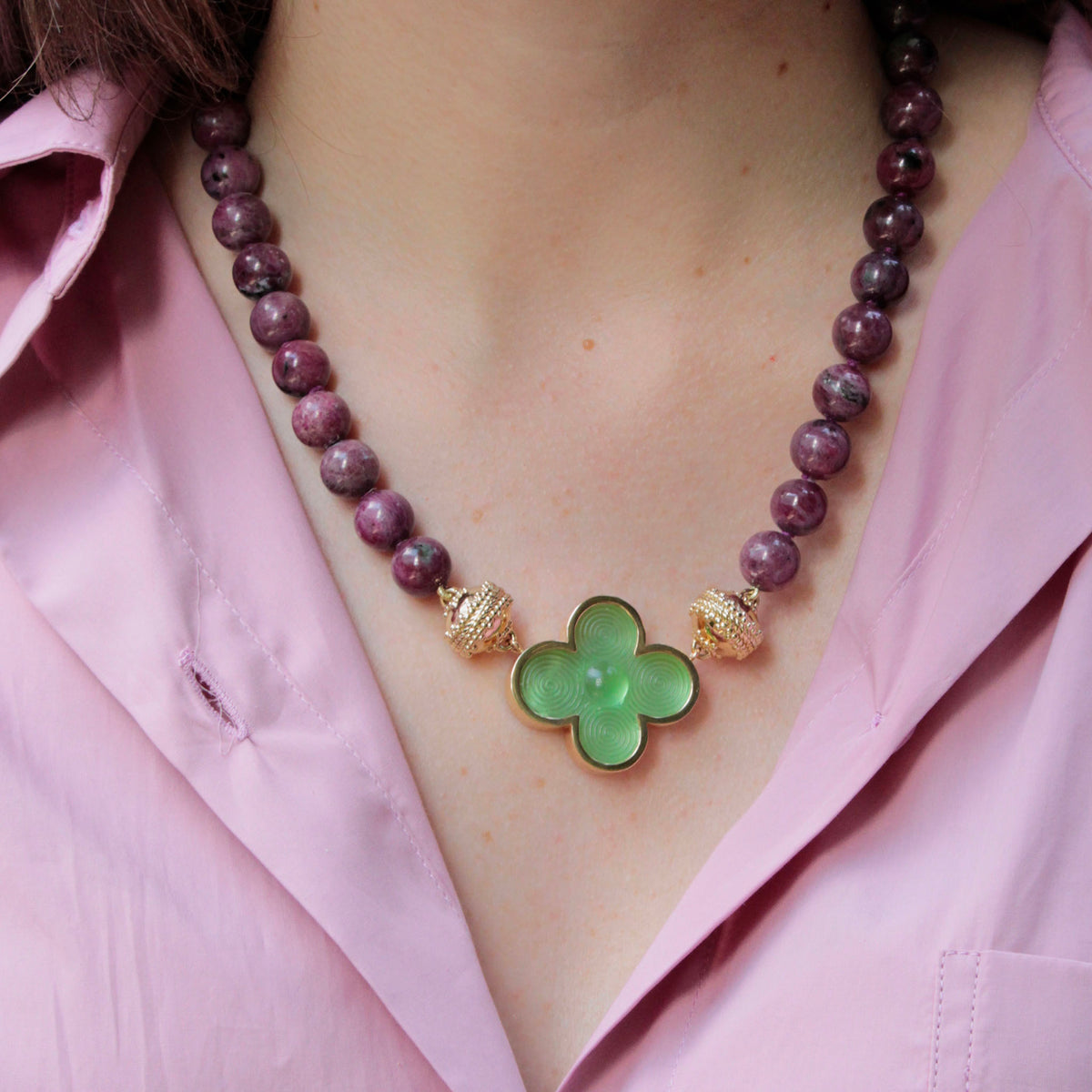 Model wearing Clara Williams Victoire 11mm Ruby Zoisite Necklace with Classic Petal Green Chiara Glass Centerpiece