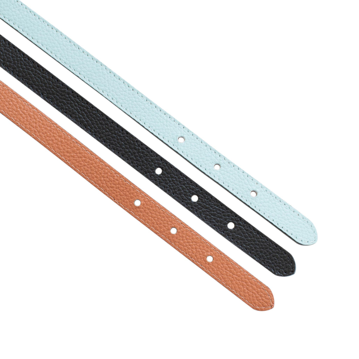 Three narrow leather belt straps in saddle brown, black, and light blue arranged diagonally on a white background.