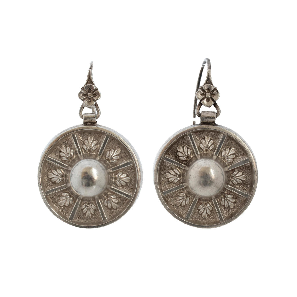 Victorian sterling silver disc drop earrings with domed centers, radiating floral motifs, and flower-accented ear wires.