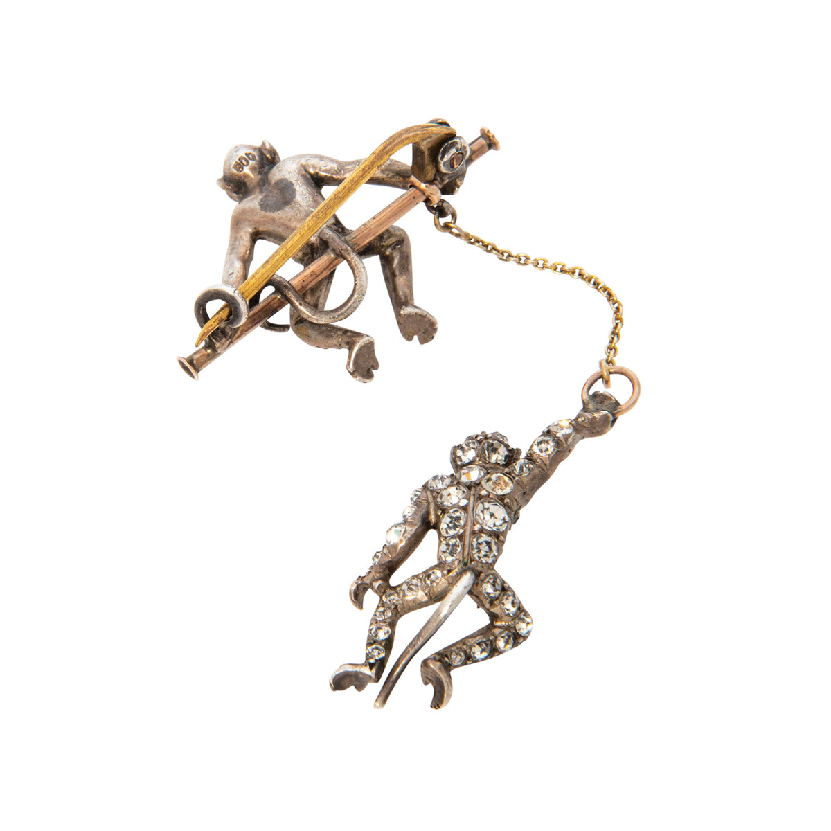 Reverse view of vintage two-monkey brooch showing the pin clasp, connecting chain, and stone-set dangling monkey.