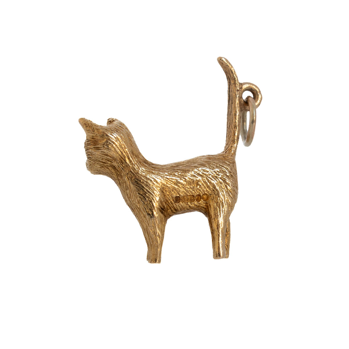 Reverse view of a vintage 9K yellow gold cat charm showing textured fur, stamped hallmarks, and an upright tail.