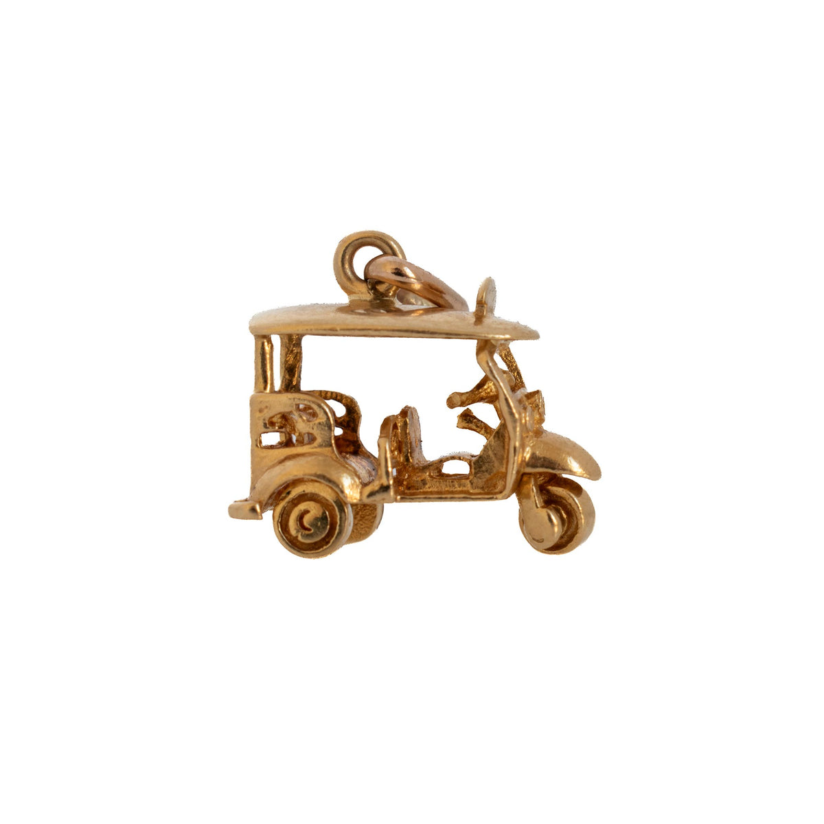 Side view of a vintage 9K yellow gold Thai tuk tuk charm showing its canopy roof, seats, handlebars, and wheels.