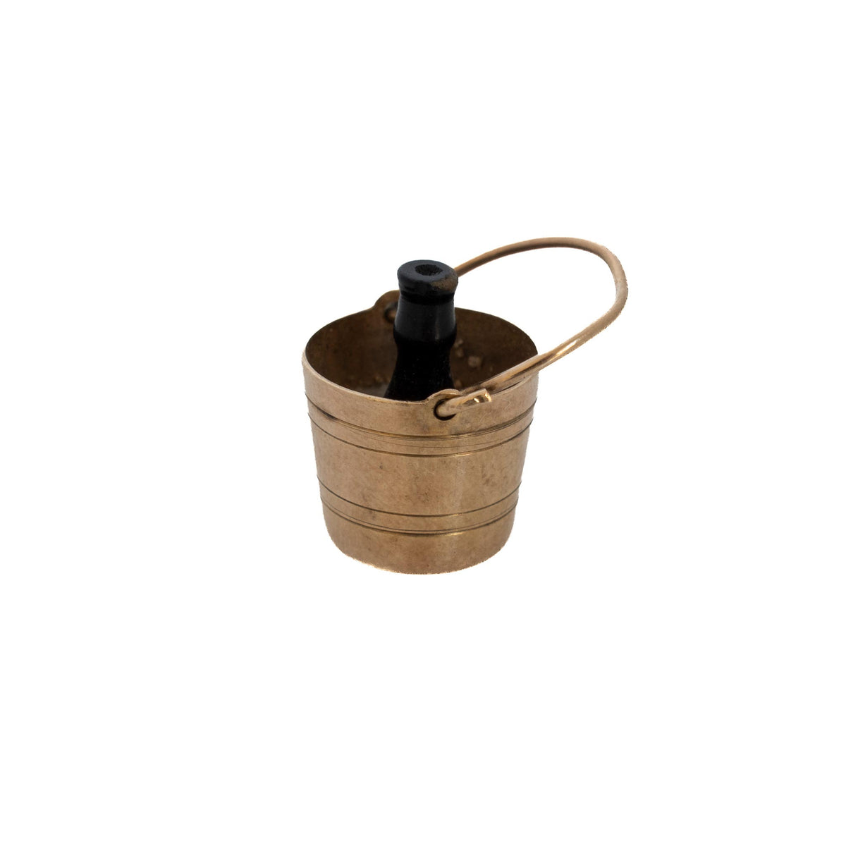Angled view of a vintage 9K gold champagne bucket charm with a black bottle and handle tilted to one side.