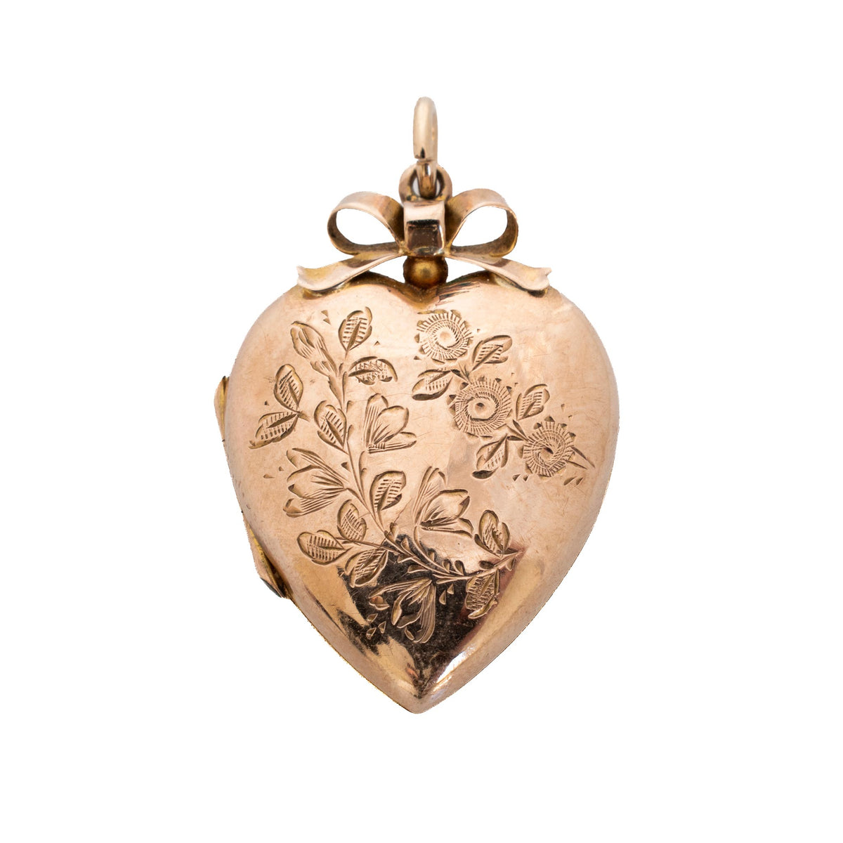 Edwardian heart locket pendant with a 9K gold front, engraved flowers and leaves, and a bow at the top.