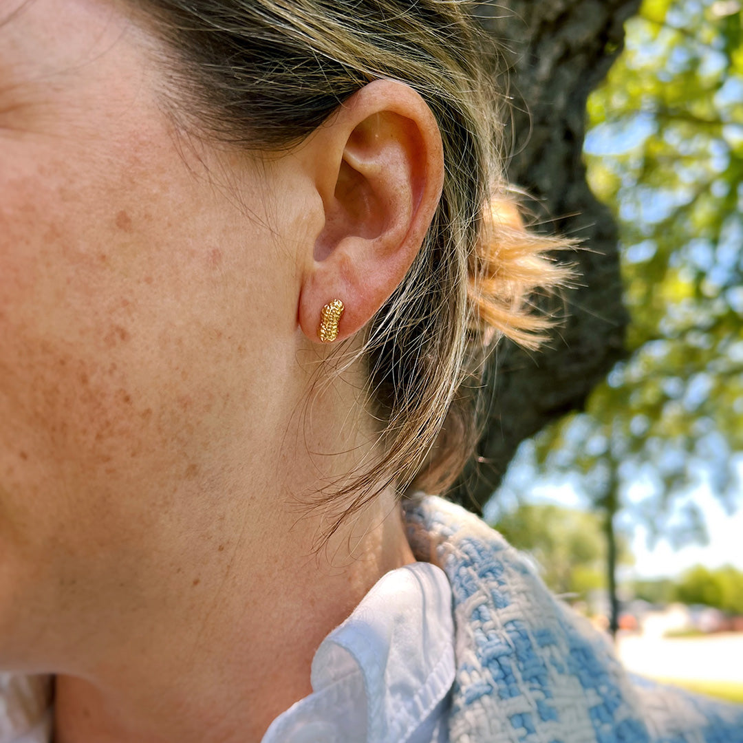 Goldbug Peanut Stud Earrings on an ear