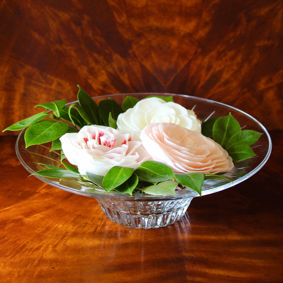 Charleston Camellia Bowl styled on a wood table with camellia blooms and leaves