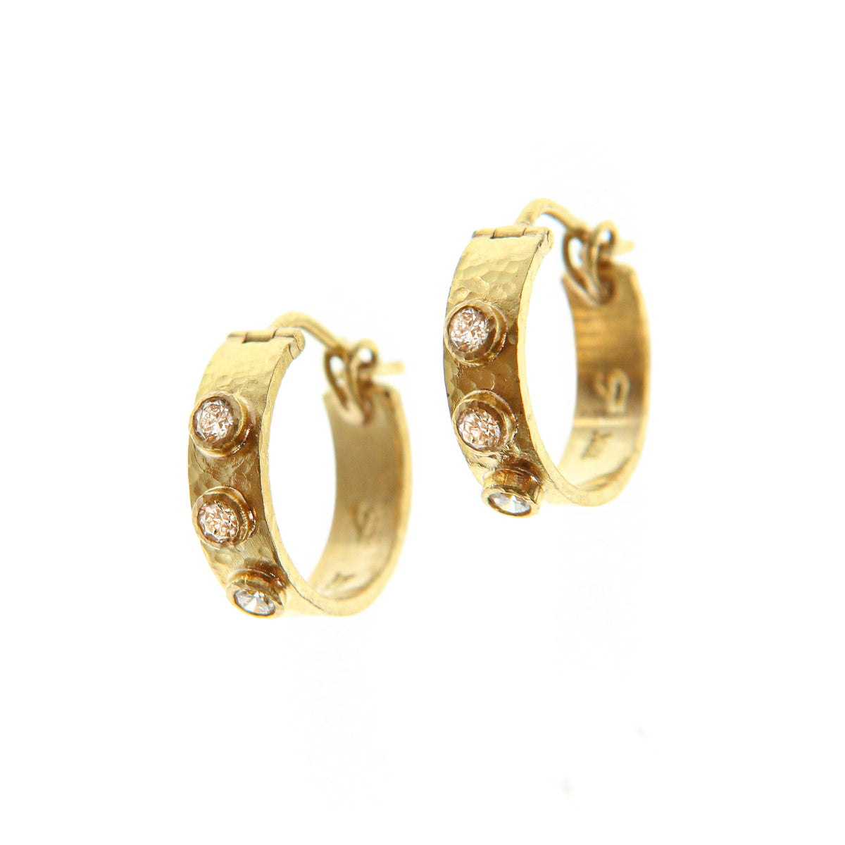 Elizabeth Locke flat ribbon hoop earrings in hammered 19K yellow gold, each with three bezel-set round diamonds.