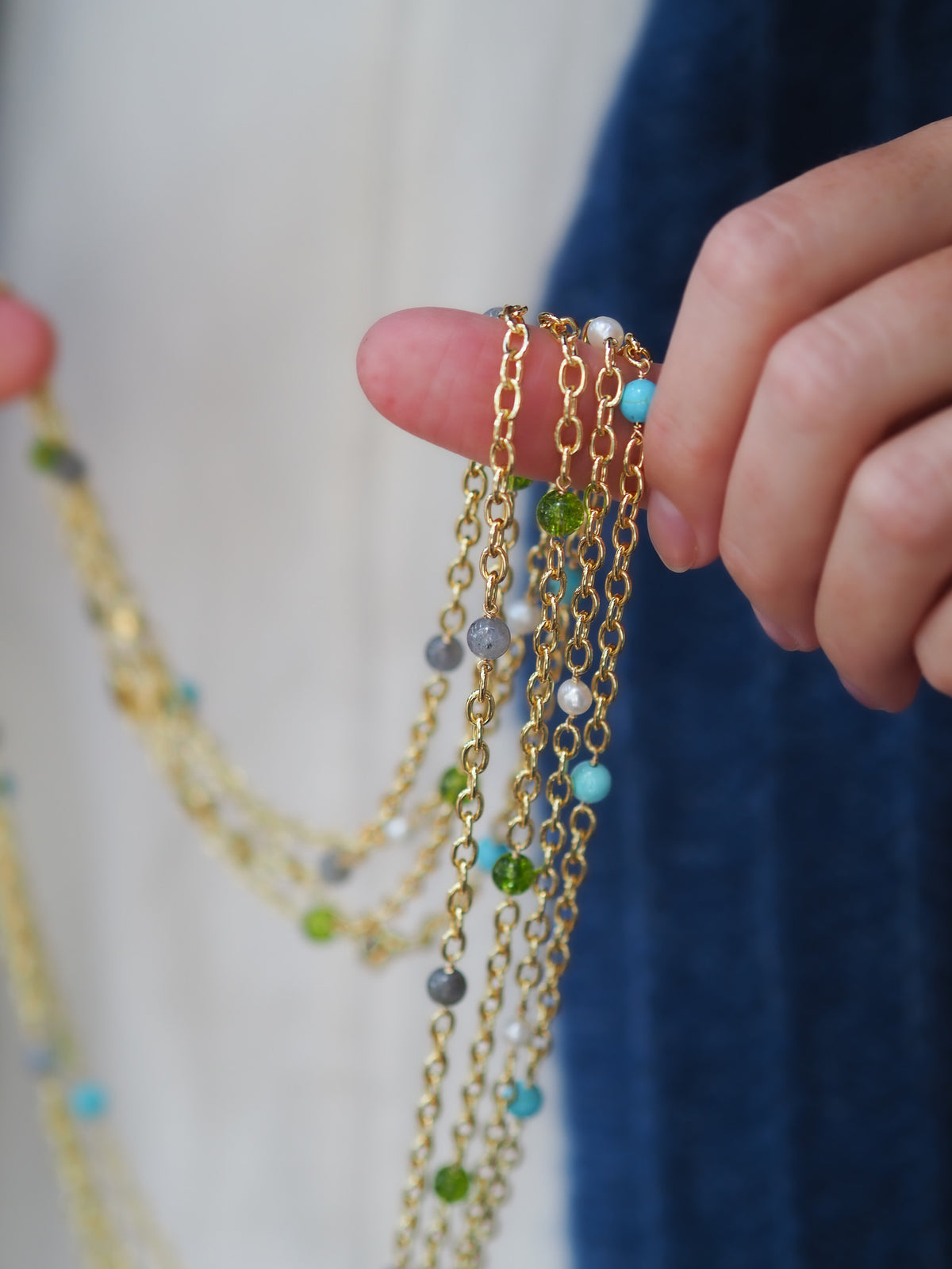 Model holding Goldbug Collection 30-inch bead thick cable chain necklaces