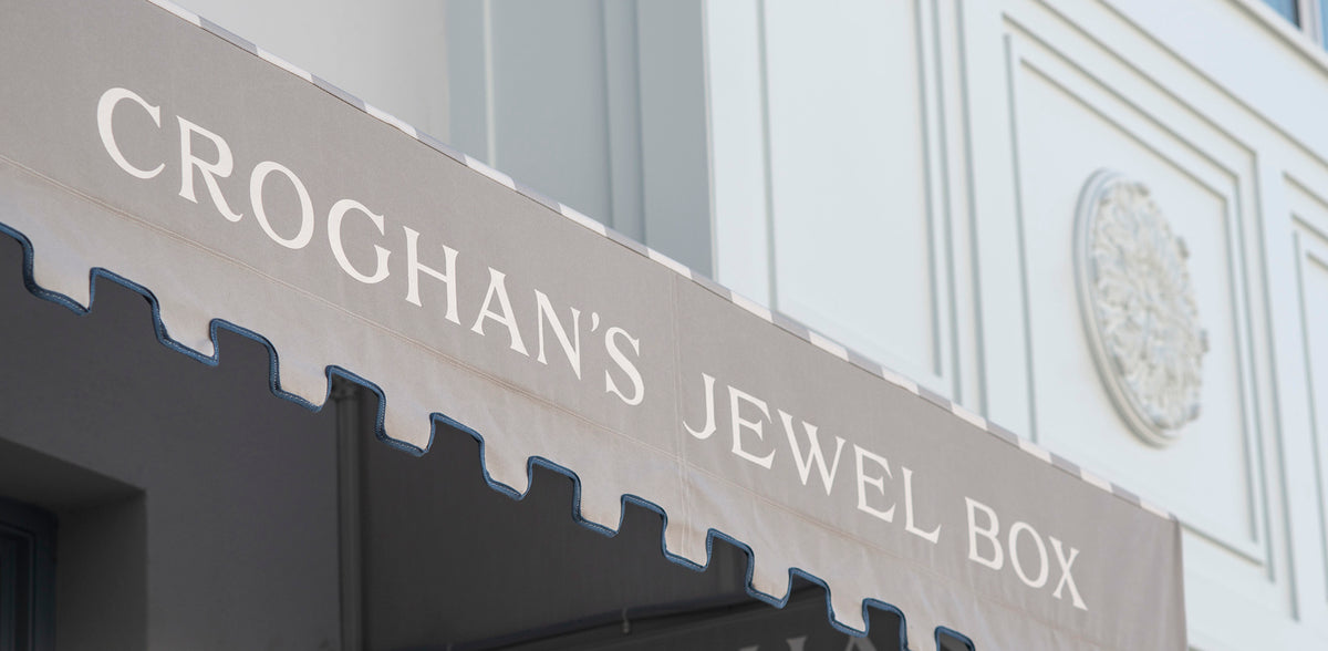 croghan's jewel box storefront under the striped awning close up