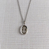 Child Sterling Silver Oval Locket Necklace with machine engraved interlocking script monogram